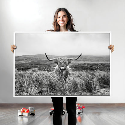 A black and white portrait of a Highland cow in a foggy Scottish countryside, capturing a rustic aesthetic and tranquil farm escape.