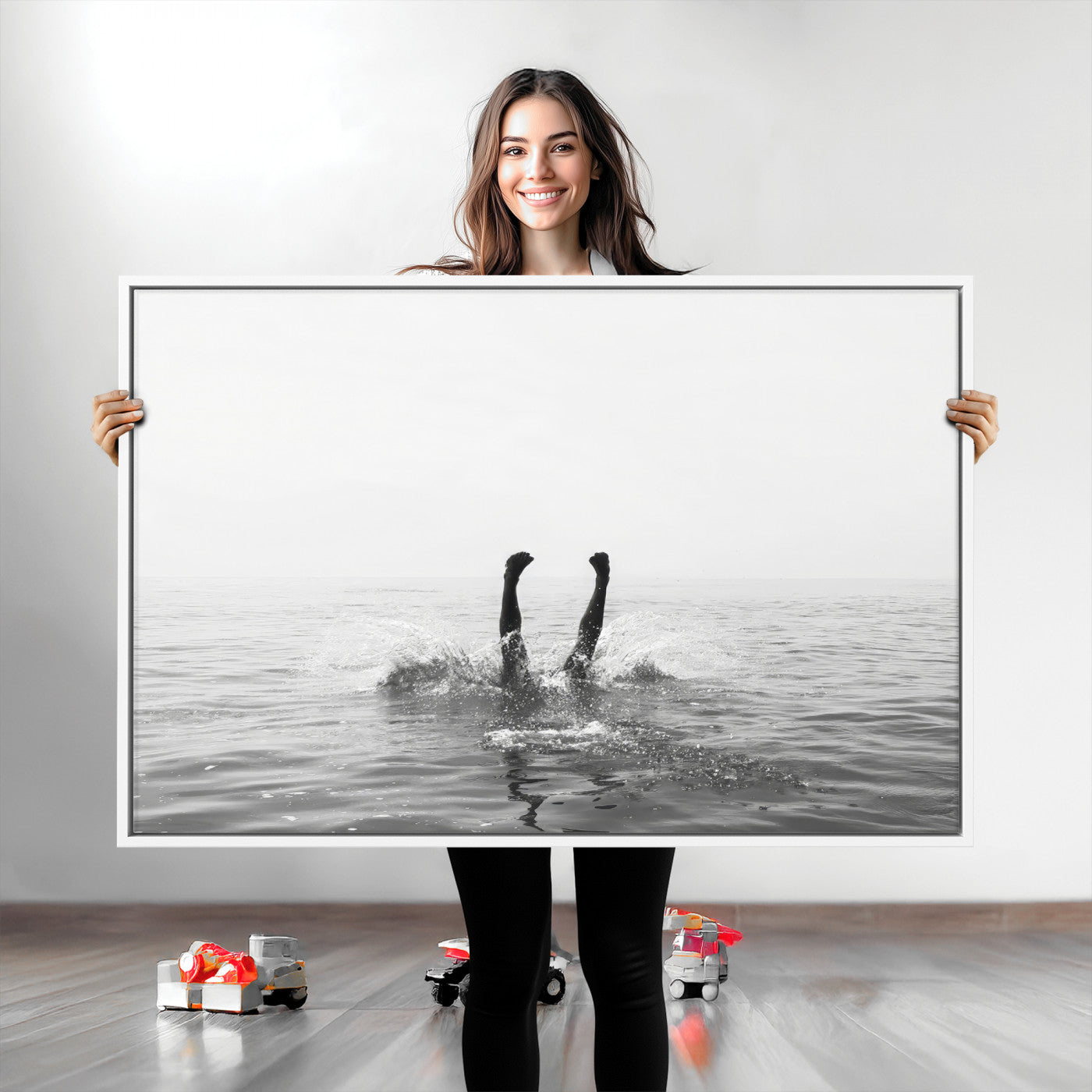 A black and white minimalist water scene capturing a playful splash as a swimmer dives upside down, creating a carefree and artistic aquatic aesthetic.