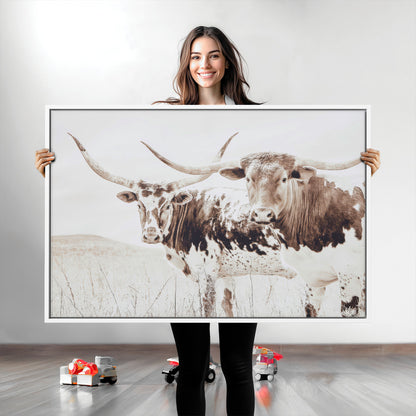 Two longhorn cows standing in a sepia-toned pasture with soft light, ideal for rustic or farmhouse-themed neutral wall decor.