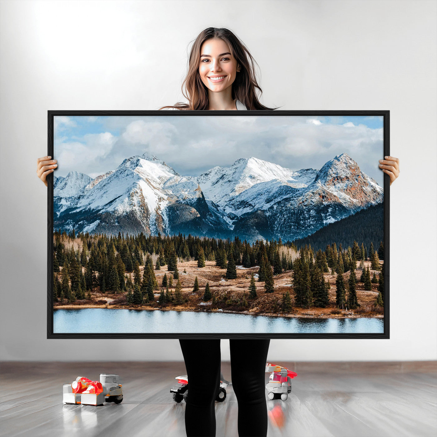 Framed canvas of snowy mountain peaks with pine forest and alpine lake, perfect for winter cabin or wilderness-inspired home decor.