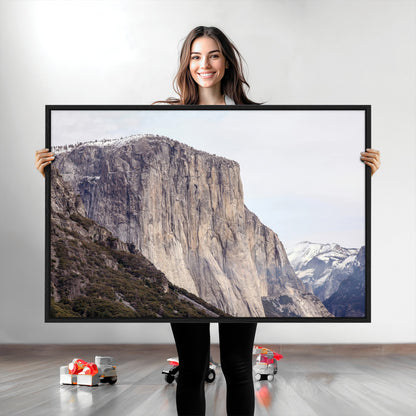 Framed canvas of El Capitan’s vertical granite face in Yosemite with snowy peaks, ideal for Sierra minimalism or mountain-inspired decor.