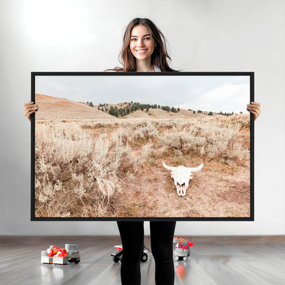 Rustic bull skull on dry sagebrush field under soft light, ideal for western minimal or desert prairie-style wall decoration.