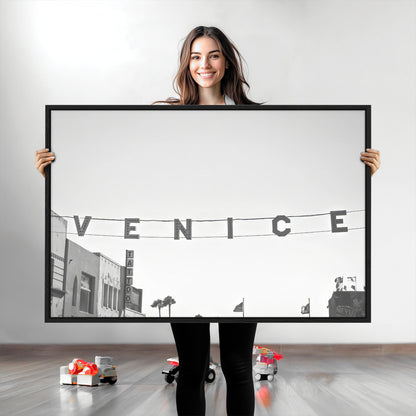 Black and white photo of Venice Beach sign and palm-lined street, perfect for urban coastal or minimalist LA-inspired wall decoration.