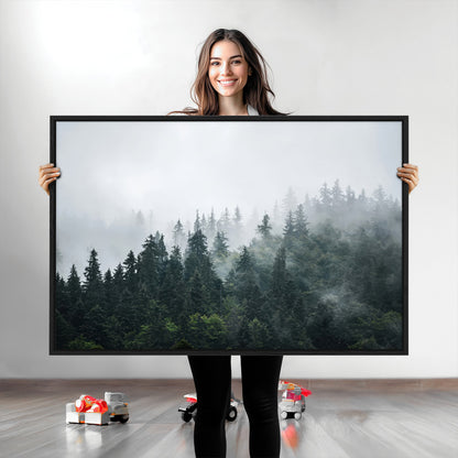 A misty evergreen forest shrouded in soft fog, creating a tranquil and moody landscape with lush green trees fading into the distance.