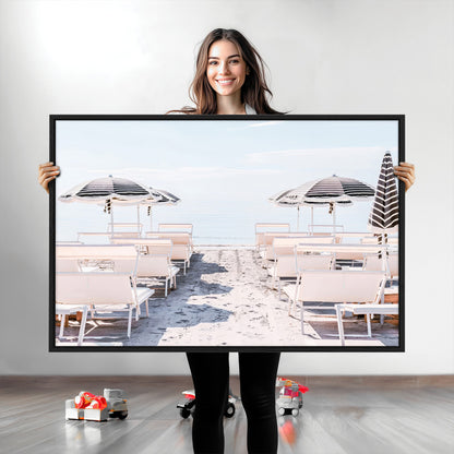 A serene minimalist beach scene featuring striped umbrellas, soft pastel sand, and an elegant lounge setup, creating a tranquil and stylish coastal retreat.
