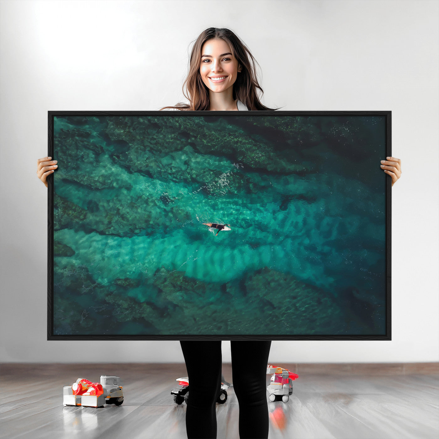 An aerial view of a solo surfer paddling through crystal-clear turquoise waters over a sunlit reef, capturing the beauty and serenity of open water surfing.