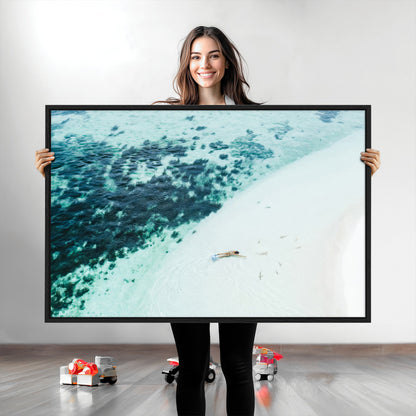 Canvas featuring an aerial view of a swimmer in shallow turquoise waters with coral patterns, ideal for tropical coastal home decor.