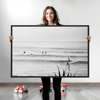 Monochrome canvas of surfers on calm ocean waves, ideal for minimalist coastal or beach-inspired interior decor.