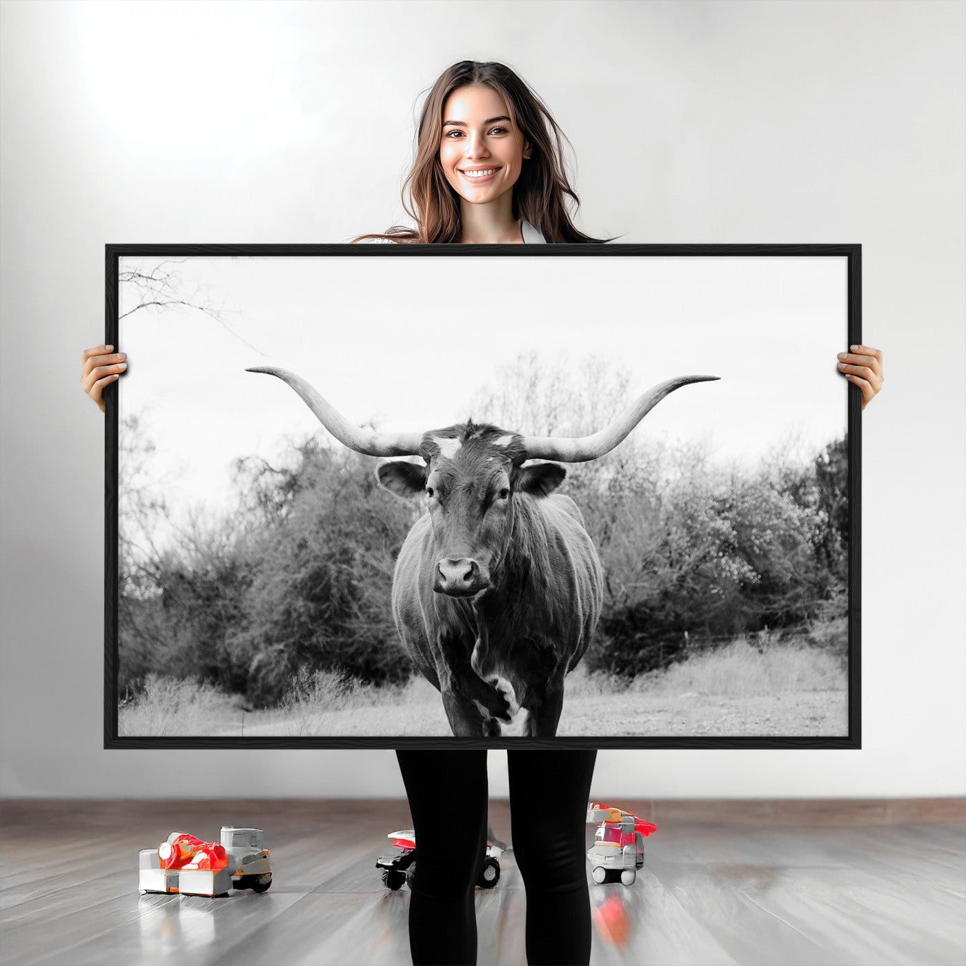Black and white photo of a longhorn cow in a field, perfect for rustic farmhouse or western-themed interior wall decoration.