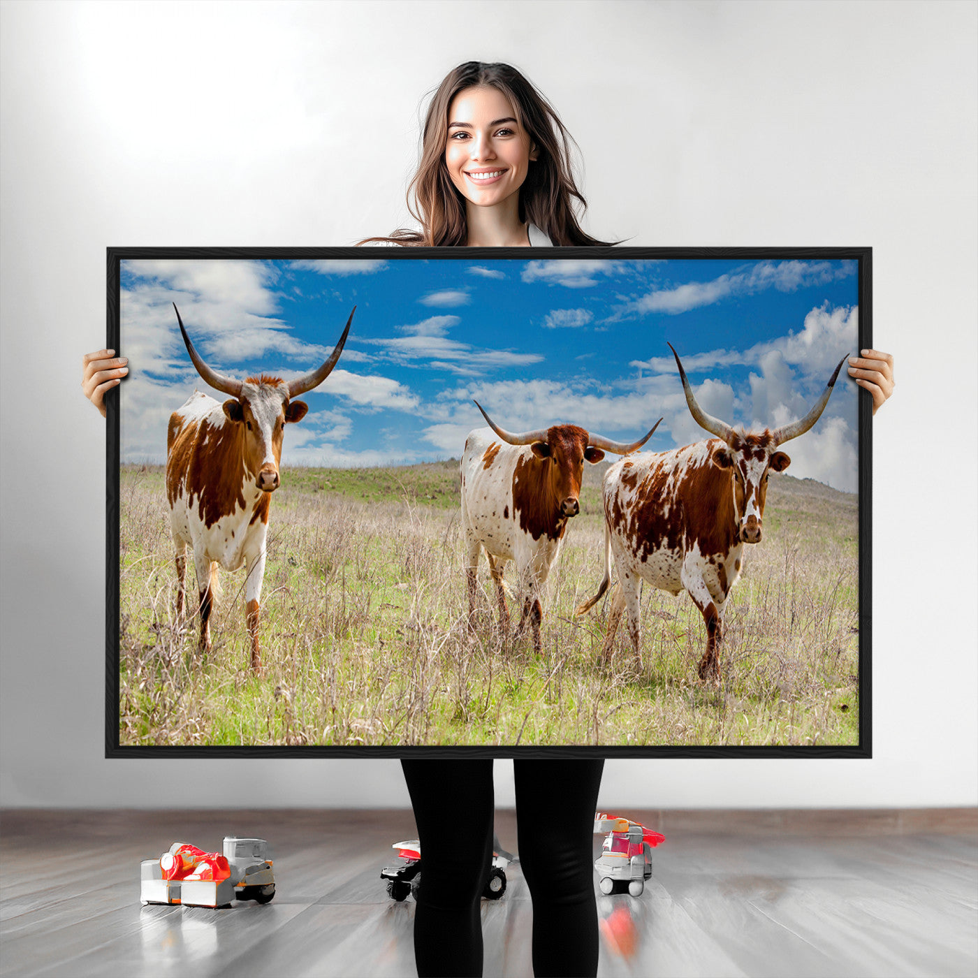 Three Texas longhorn cattle standing in dry grass under a bright blue sky, ideal for farmhouse or western rustic home decor.