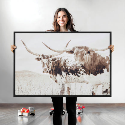 Two longhorn cows standing in a sepia-toned pasture with soft light, ideal for rustic or farmhouse-themed neutral wall decor.