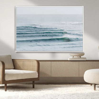 High-angle view of surfers lining up across layered ocean waves, ideal for minimal coastal or surf-inspired room decor.