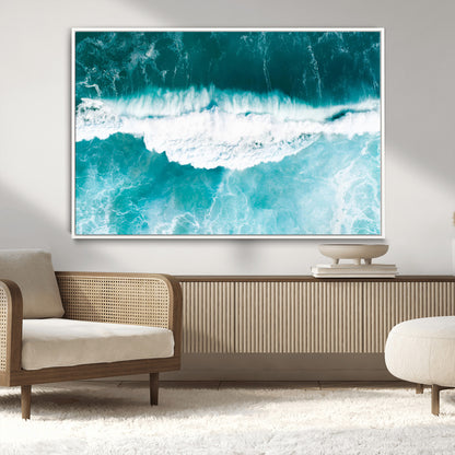 Aerial view of turquoise ocean waves crashing with white foam, perfect for tropical coastal or modern beach-style home decor.