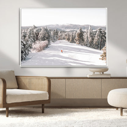 Bright ski trail lined with snow-covered pines and a skier in orange, perfect for alpine adventure or winter sports-inspired decor.