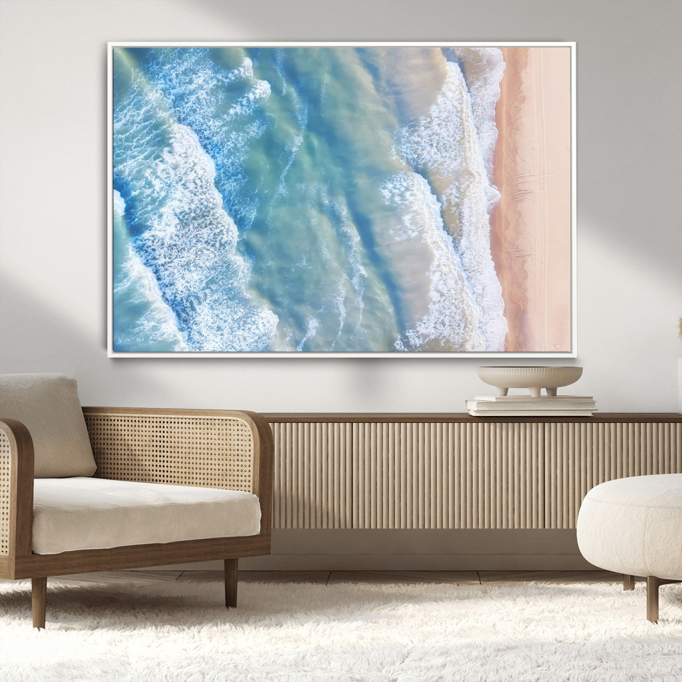 Aerial photo of soft blue waves meeting sandy shore, perfect for modern coastal or beach-themed decor with a light and tranquil aesthetic.
