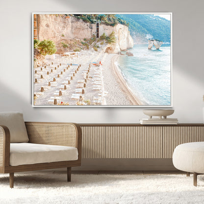 Wall art of a calm Mediterranean beach with rows of sun loungers and umbrellas in soft pastel tones, perfect for light coastal or vacation-themed decor.