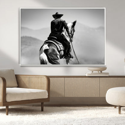 Black and white canvas of a cowboy on horseback with moody tones, perfect for rustic western or country-inspired home decor.