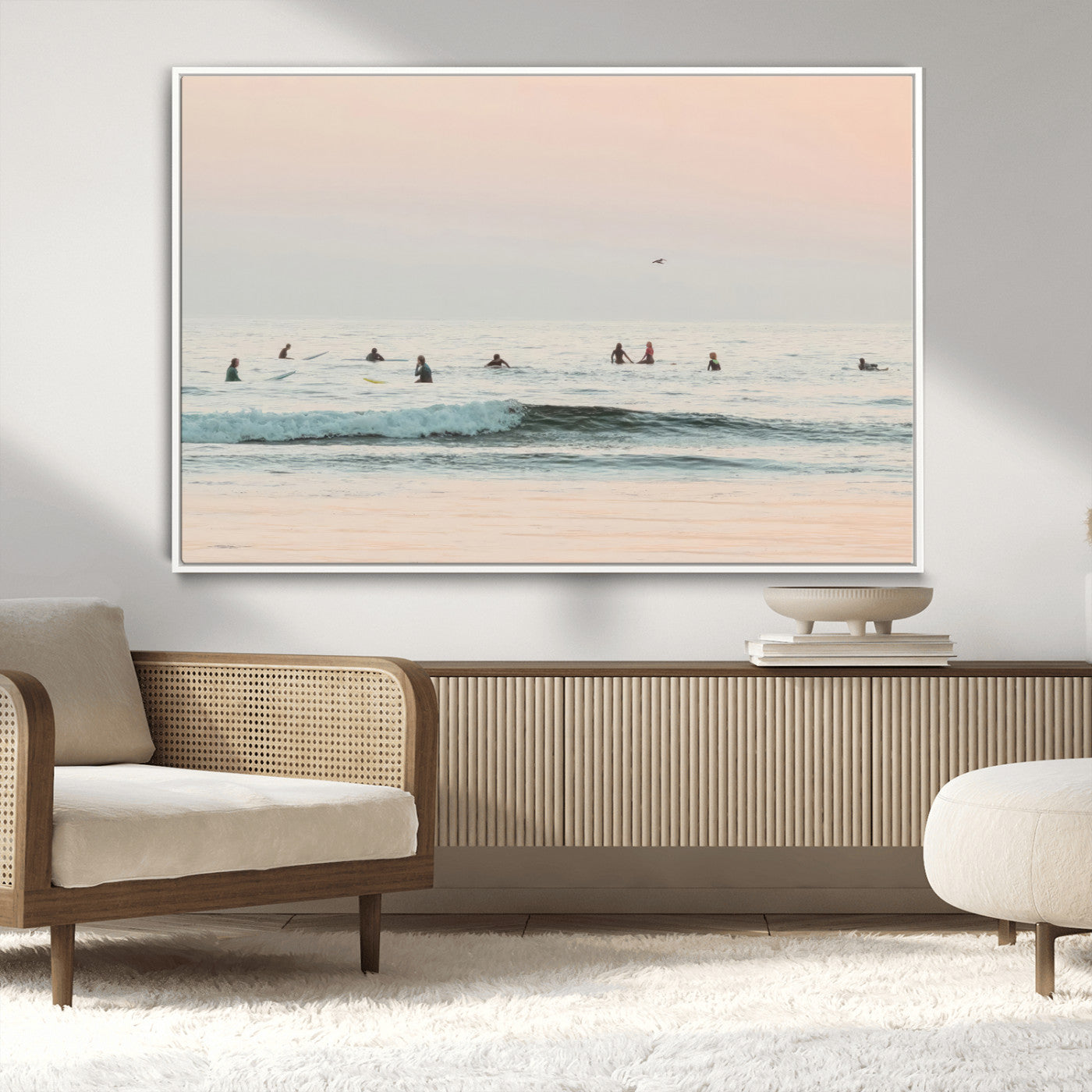 Dreamy photo of surfers waiting on soft pastel waves under a pink sunset sky, ideal for soft coastal minimalist or serene ocean-themed home decor.