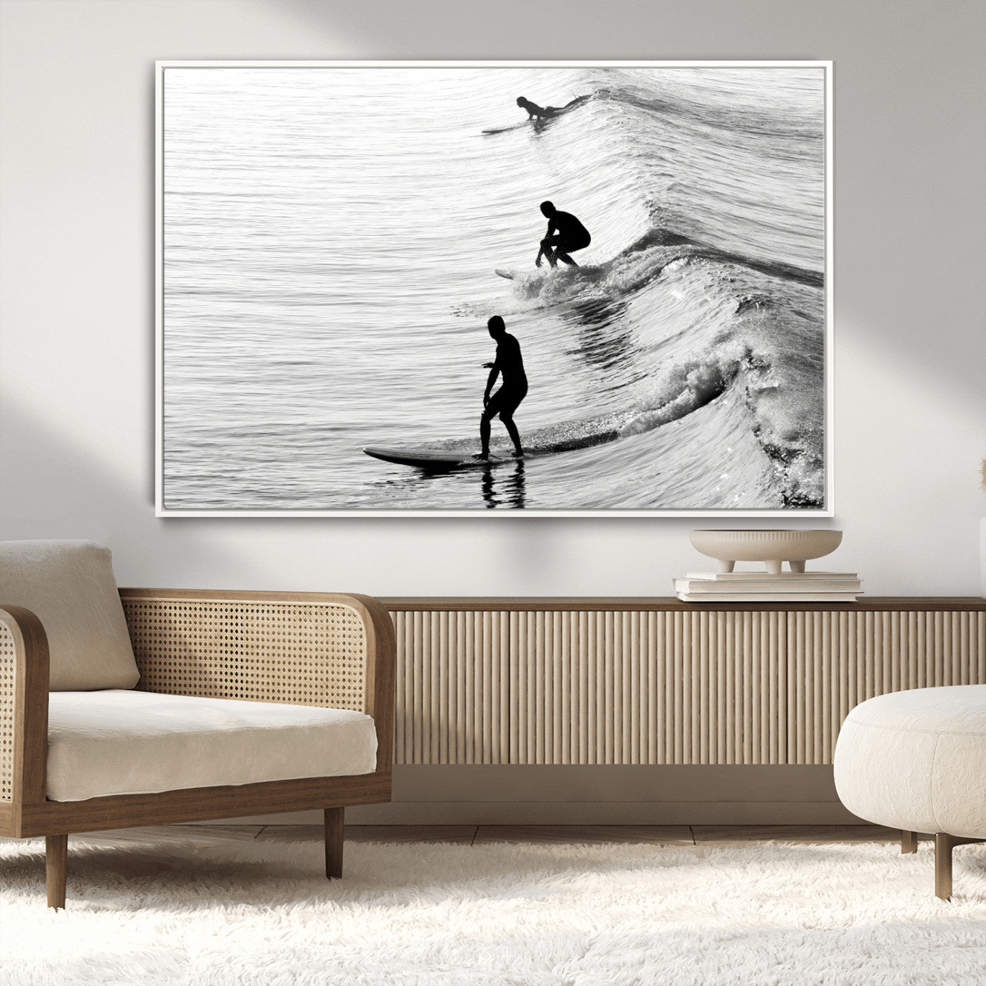 Black and white photo of surfers riding waves in a moody, high-contrast scene, ideal for modern coastal or surf-inspired home decor.