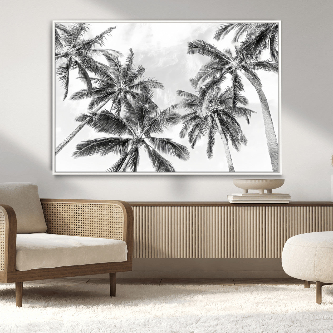 Black and white tropical palm trees viewed from below, swaying gently against a bright sky, creating a serene and elegant coastal atmosphere.