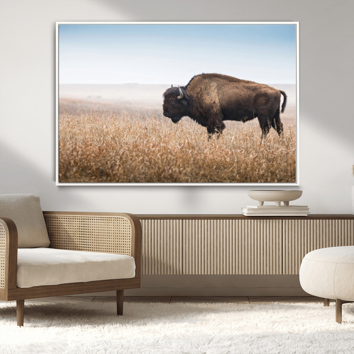 A majestic bison standing in an open prairie field, its strong form blending into the golden grass under a vast blue sky, evoking the wild spirit of the American plains.
