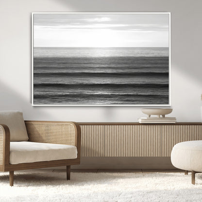 Minimalist black and white ocean view with layered waves reflecting sunlight, evoking a sense of calm and coastal serenity.