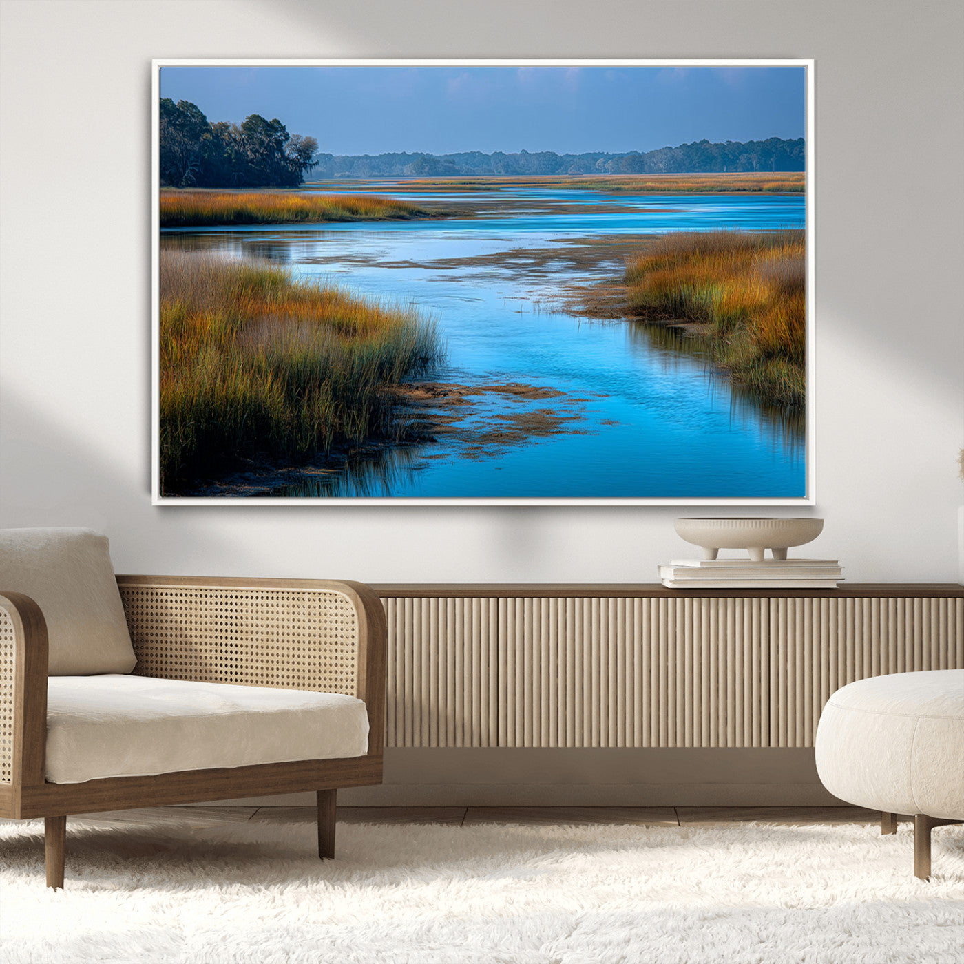 A peaceful marshland scene with calm blue water reflecting the surrounding grasses and trees, capturing the beauty of nature in a serene landscape.