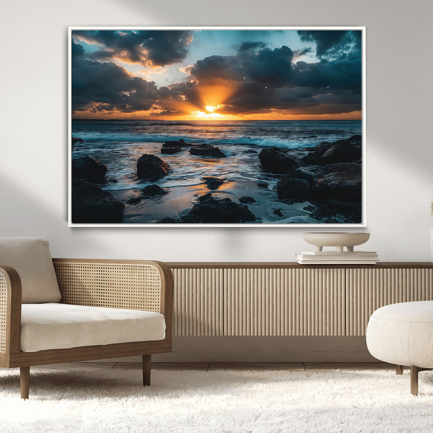 An awe-inspiring sunset over the ocean with rays of light piercing through dramatic clouds, creating a beautiful seascape with rocks in the foreground.