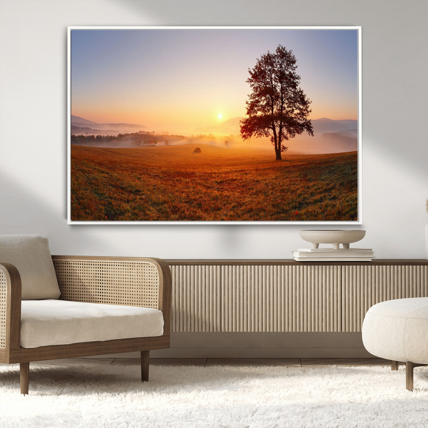 A tranquil landscape at sunrise with a mist-covered field and a lone tree, creating a peaceful and natural atmosphere.