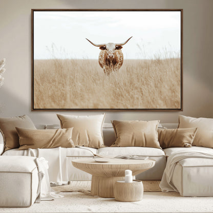 Texas Longhorn bull standing alone in dry grass with neutral tones, ideal for rustic western or cowboy-themed wall decor.