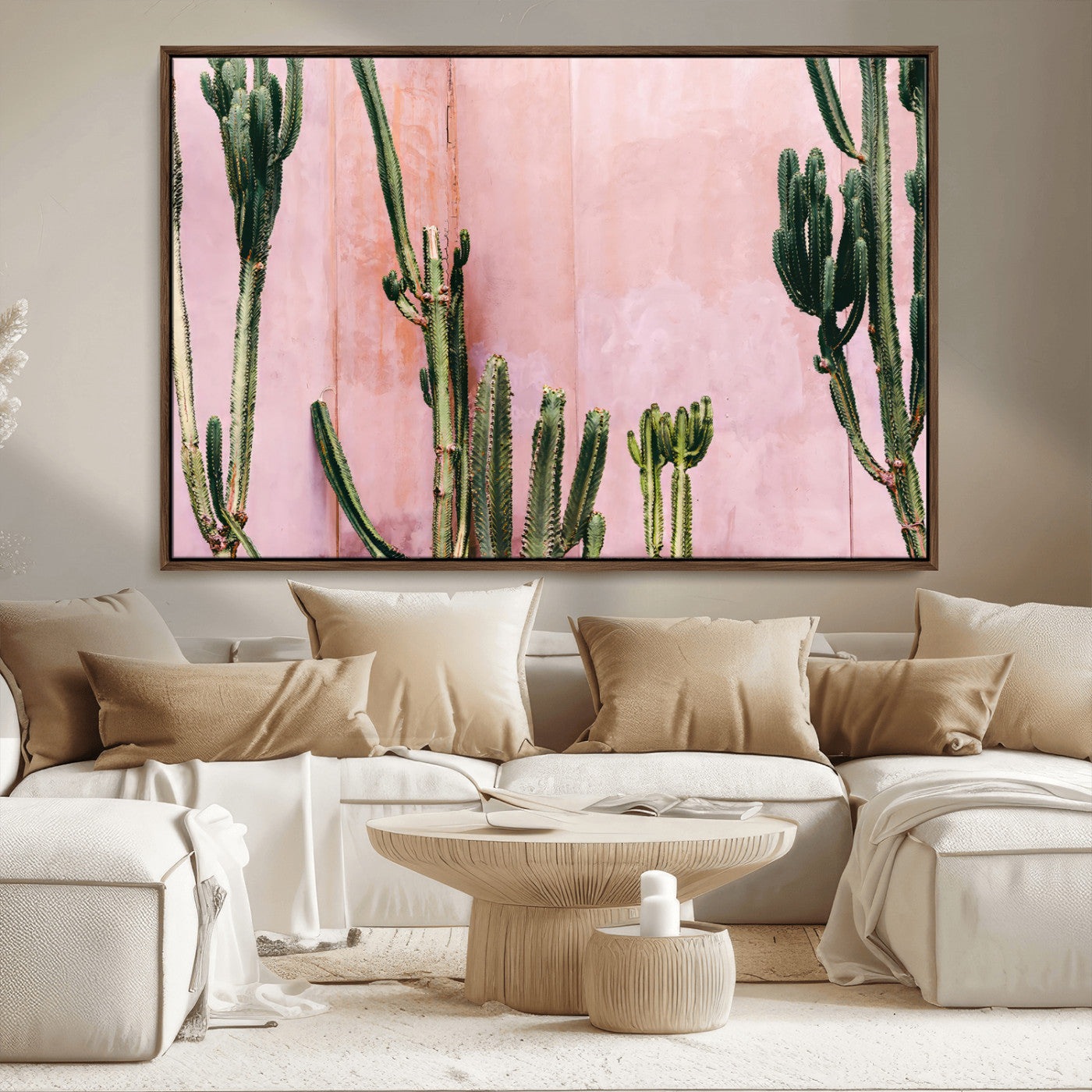 Framed canvas of tall green cacti against a soft pink wall, ideal for modern desert or colorful southwest-inspired home decor.