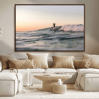Framed canvas of a female surfer balancing on a wave at sunset, perfect for serene surf or ocean-inspired coastal decor.