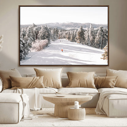 Bright ski trail lined with snow-covered pines and a skier in orange, perfect for alpine adventure or winter sports-inspired decor.