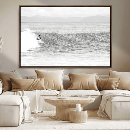 Monochrome photo of a surfer riding a wave with distant mountains, ideal for coastal motion or black and white surf-themed wall decor.