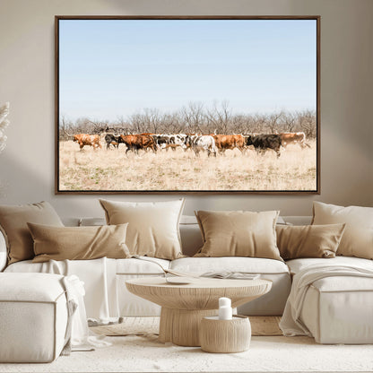 Framed wall art of Texas longhorn cattle walking through a dry, neutral-toned prairie, perfect for rustic farmhouse or western-themed home decor.
