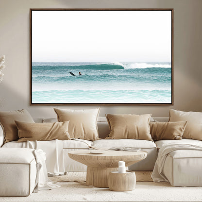 Minimalist photo of a lone surfer on calm aqua waves under bright sky, perfect for Scandinavian coastal or serene ocean-inspired home decor.