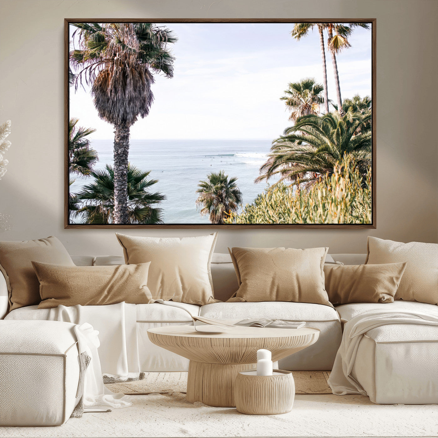 Scenic coastal view with tall palm trees overlooking a calm ocean, soft blue waves, and surfers in the distance, creating a peaceful tropical vibe.