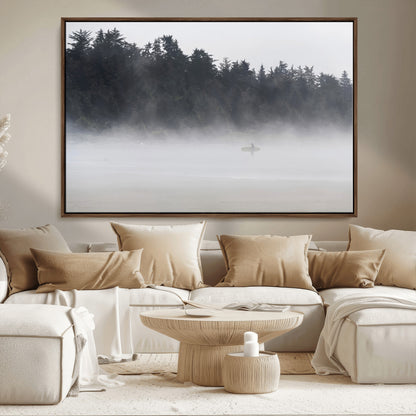 A lone surfer carrying a board through a misty shoreline, surrounded by dense trees and fog, creating a peaceful and mysterious coastal scene.