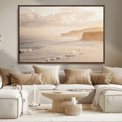 Golden hour seascape with misty cliffs and gentle waves rolling towards the shore, capturing a tranquil and warm coastal atmosphere.