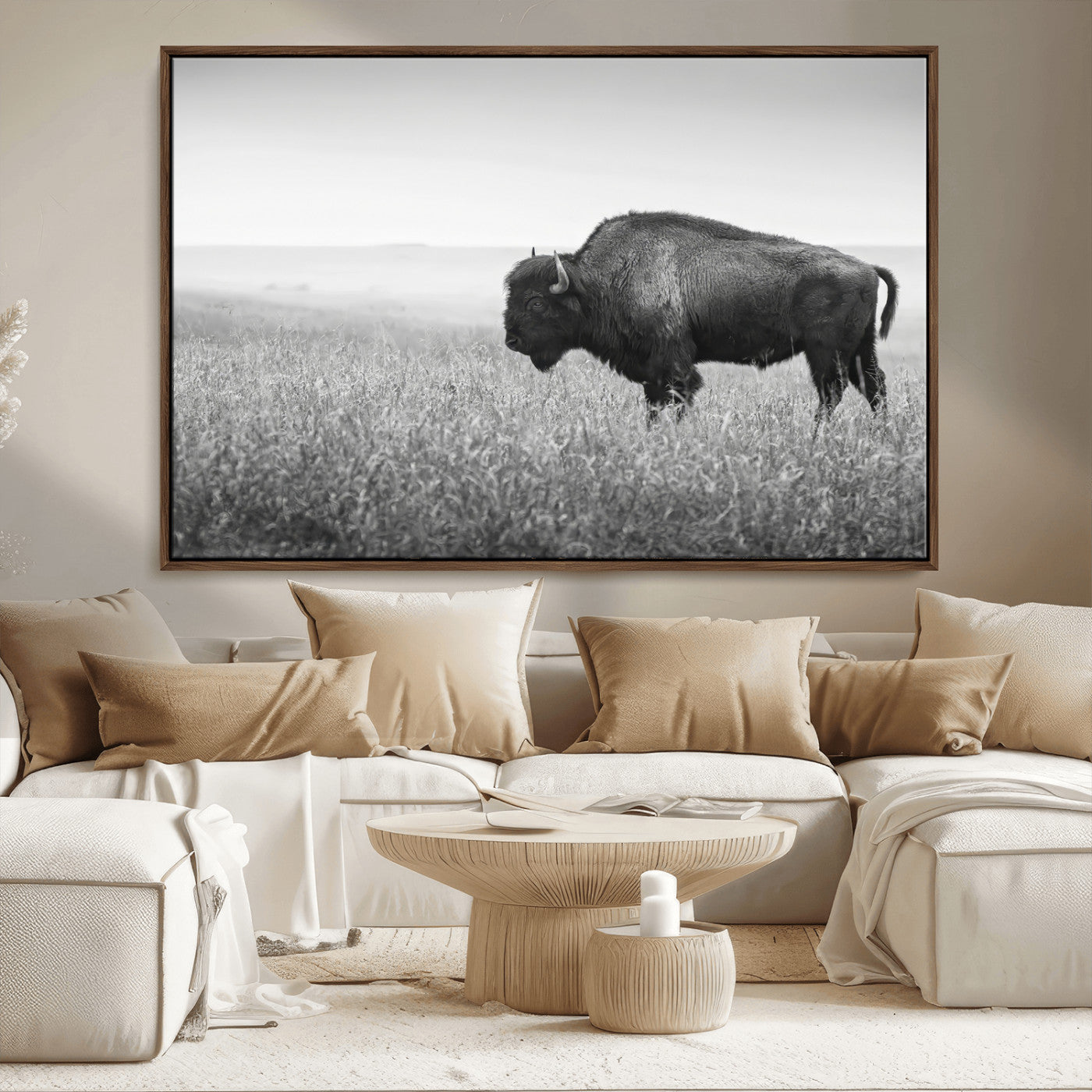 A black and white photograph of a majestic bison standing in a vast grassy prairie, evoking a sense of wilderness and strength.