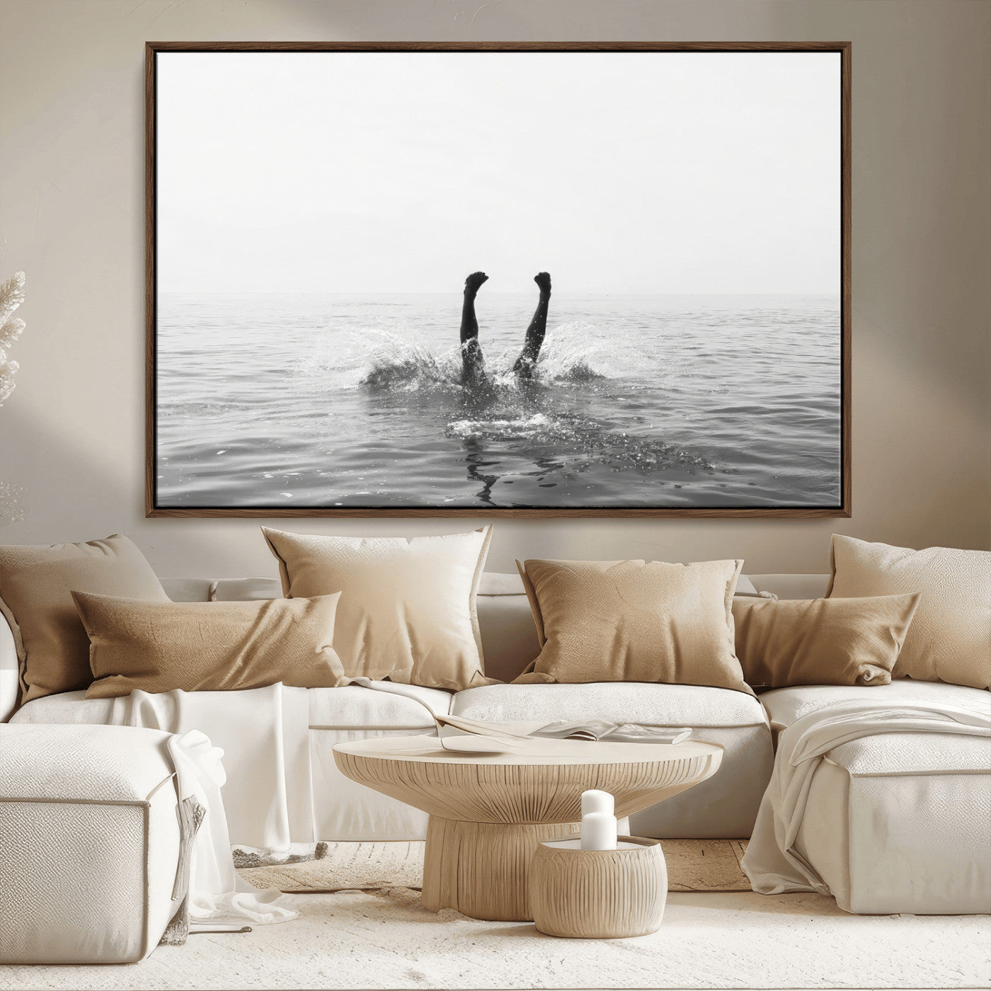 A black and white minimalist water scene capturing a playful splash as a swimmer dives upside down, creating a carefree and artistic aquatic aesthetic.