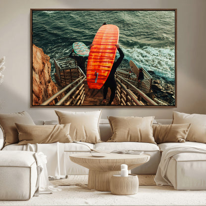 A surfer carrying a bold orange surfboard down a rugged staircase toward the ocean, bathed in golden hour light, capturing the energy of coastal adventure.