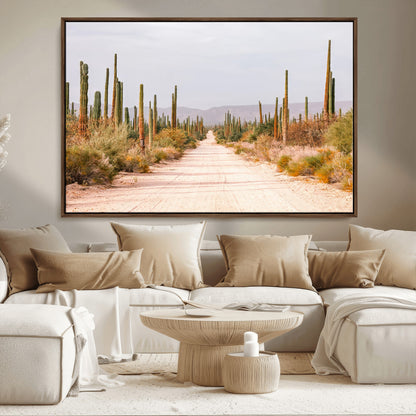 A desert road lined with saguaro cacti under a golden sky, creating a warm southwestern feel, perfect for boho or rustic decor.