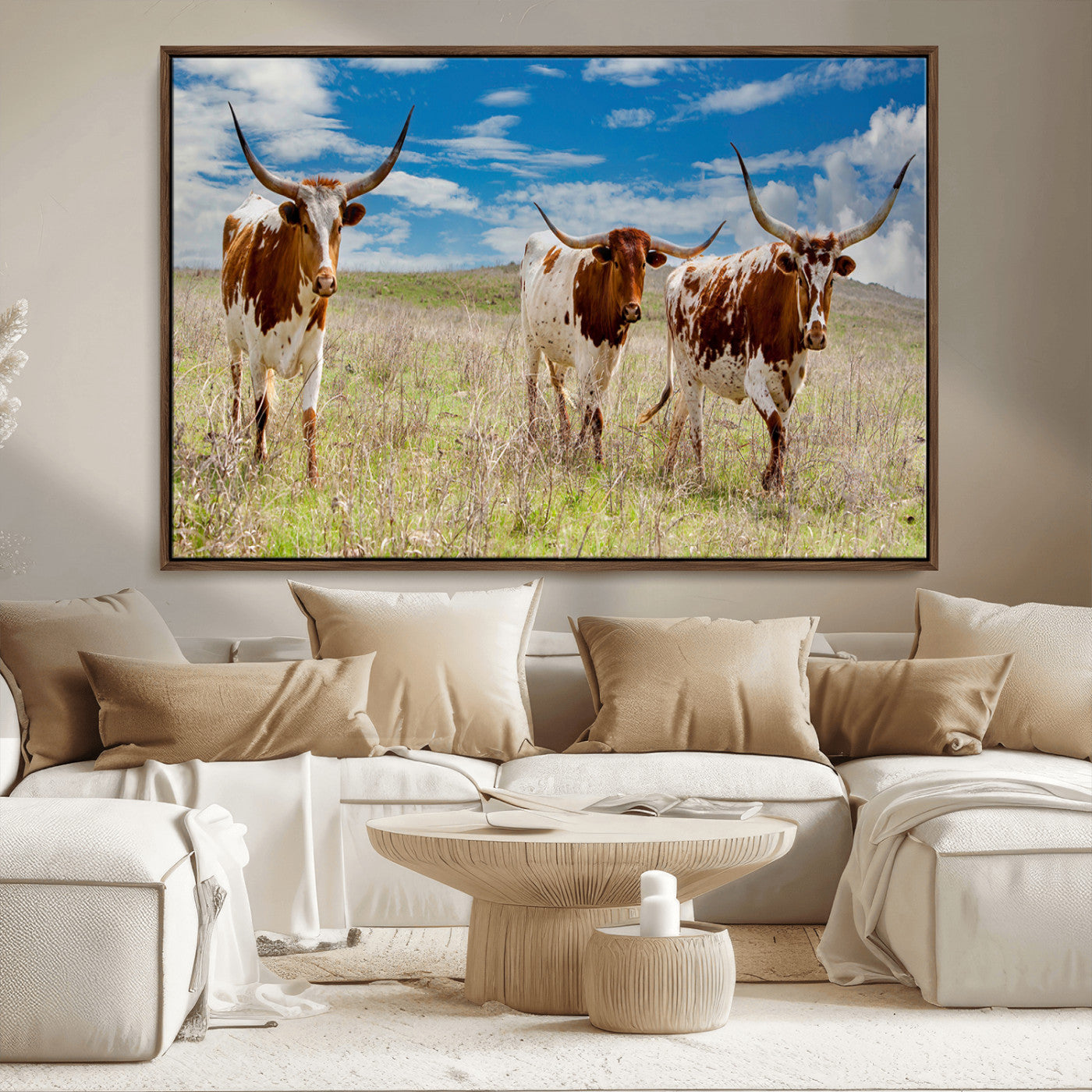 Three Texas longhorn cattle standing in dry grass under a bright blue sky, ideal for farmhouse or western rustic home decor.