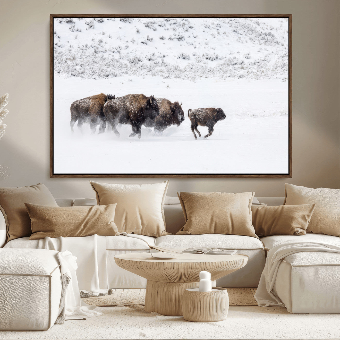 Bison herd running through a snowy open field with mountain backdrop, perfect for rustic or western-themed wall decoration.