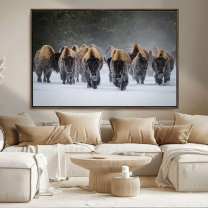 A herd of American bisons walking through deep snow in a forest, evoking a powerful rustic wilderness mood for western-style interiors.