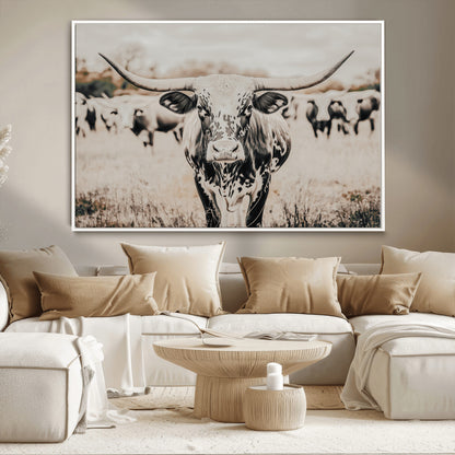 Canvas of a speckled Texas longhorn standing boldly in a field with a herd behind, perfect for rustic western or farmhouse wall decor.