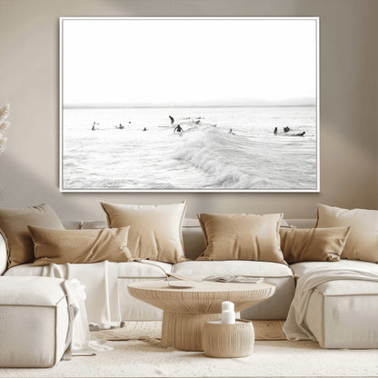 Monochrome photo of surfers riding and waiting on ocean waves, ideal for surf-themed or coastal energy wall decor.