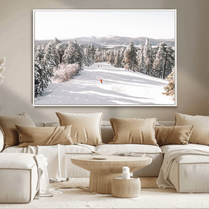 Bright ski trail lined with snow-covered pines and a skier in orange, perfect for alpine adventure or winter sports-inspired decor.
