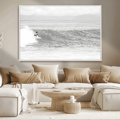 Monochrome photo of a surfer riding a wave with distant mountains, ideal for coastal motion or black and white surf-themed wall decor.